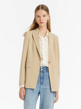 a lady in a notched lapel one button blazer with jeans